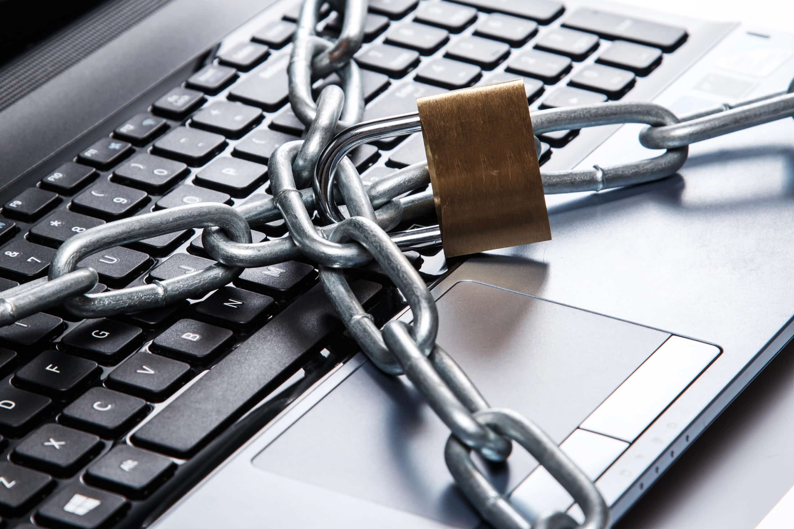 A chained-up computer symbolizes the ways traditional IT Services hold your business back. 