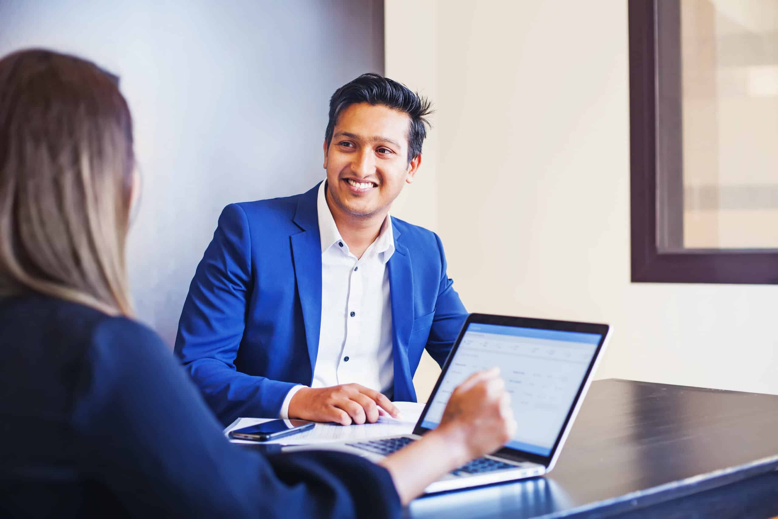 Woman explaining onboarding for new employees to a man.